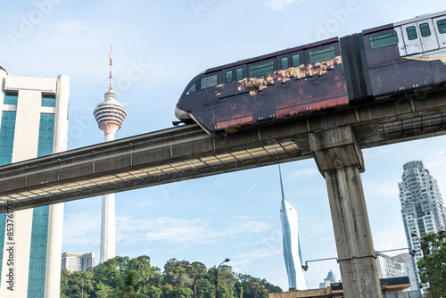 Photography An LRT train,runs along the efficient overhead railway system,high above KL city center,avoiding busy roads below,Kuala Lumpur,Malaysia