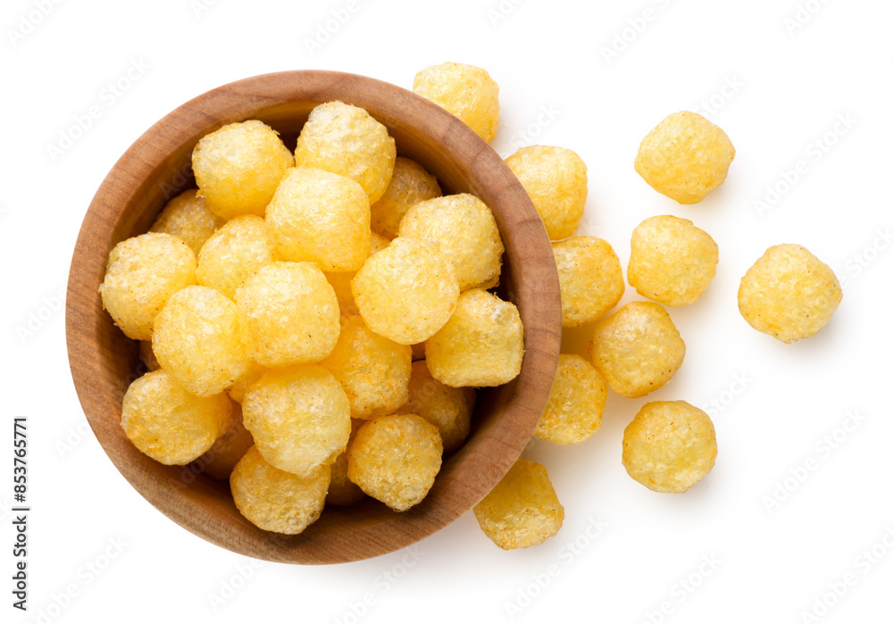 Corn balls in a wooden plate and scattered on a white background. Top view Corn balls in a wooden plate and scattered on a white background. Top view
