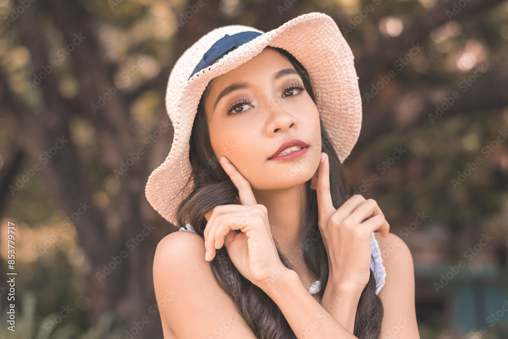 Young asian woman in hat posing in boho fashion Young asian woman in hat posing in boho fashion