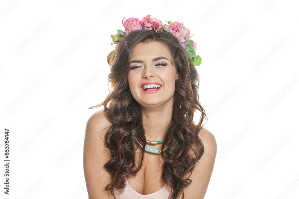 Naklejka premium Laughing fashion brunette model with make-up, fresh clear skin, shiny long wavy hairstyle and pink spring flower. Skin care, haircare, cosmetology and beauty concept