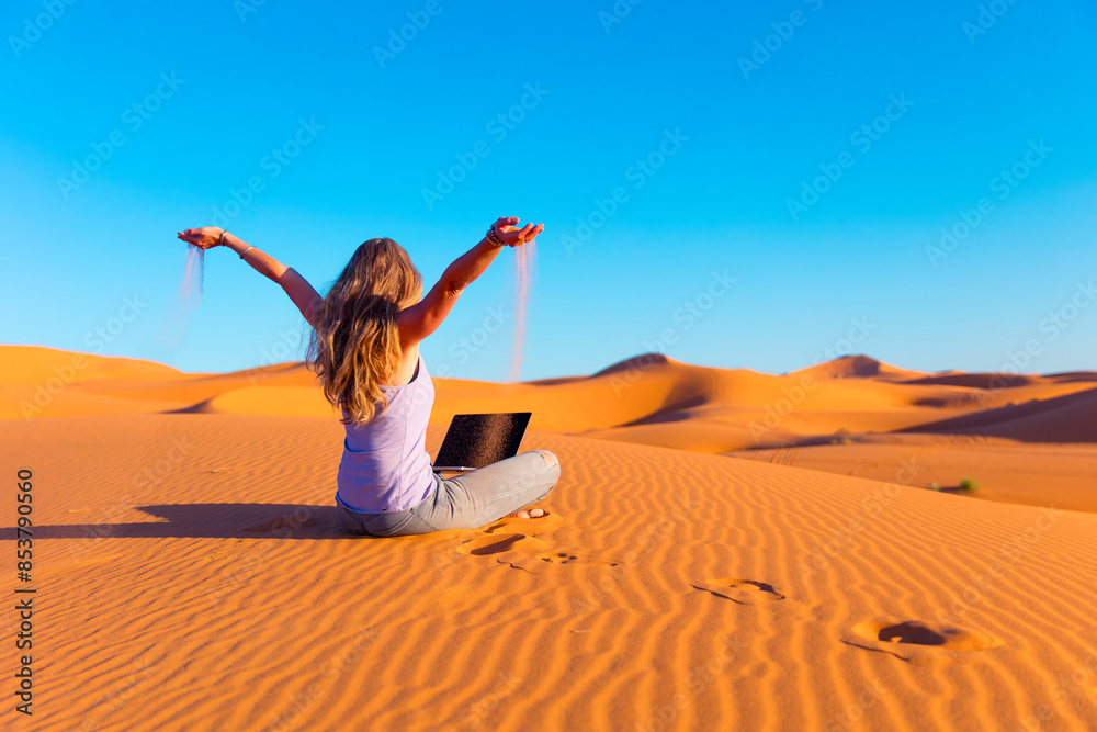 Happy digital nomal with laptop working in the desert Happy digital nomal with laptop working in the desert