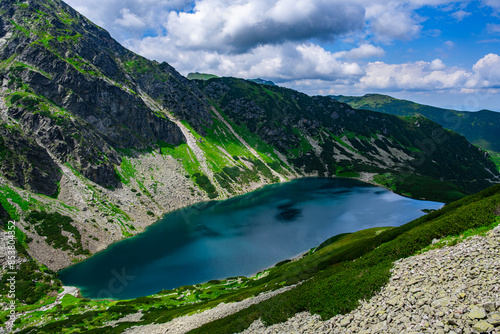 Fototapeta Naklejka Na Ścianę i Meble -  Beautiful landscape of a lake between rocky mountains with a beautiful sunny sky in Poland