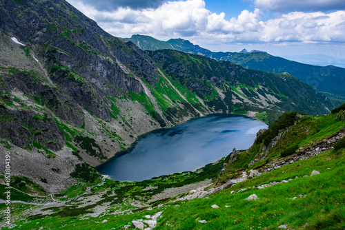 Fototapeta Naklejka Na Ścianę i Meble -  A beautiful lake lying under a high rocky mountain range in Poland