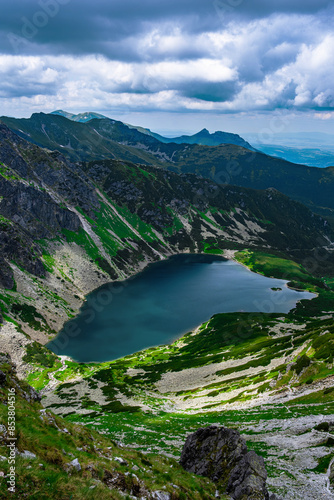 Fototapeta Naklejka Na Ścianę i Meble -  High angle view of a lake in the rocky mountains on an overcast day in Poland
