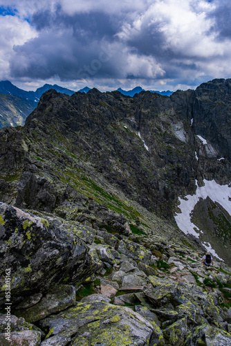 Fototapeta Naklejka Na Ścianę i Meble -  The top of a rocky mountain range in cloudy weather with tourists in Poland