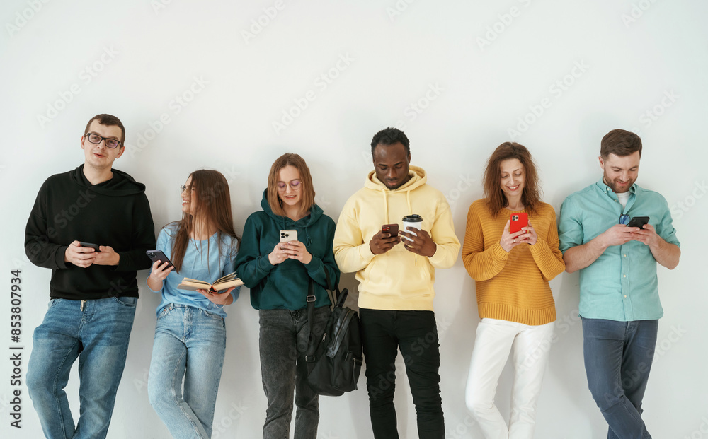 Obraz premium Standing against white background. Group of young people are together