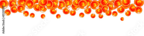 Vitamin E round capsules scattered randomly.