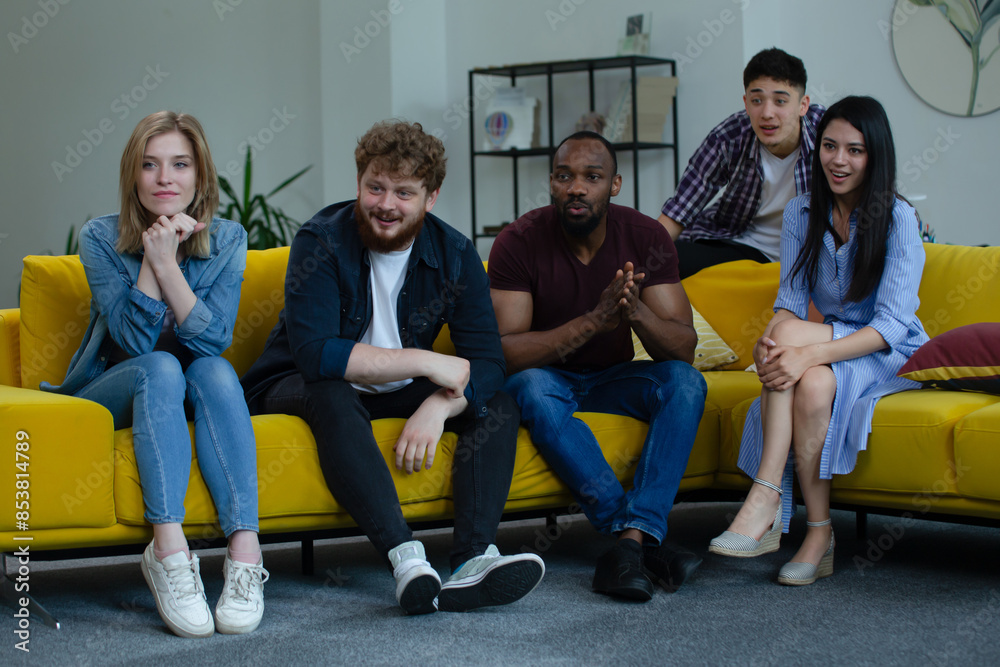 Obraz premium Multiethnic Enthusiastic Team Watching Presentation in Modern Office