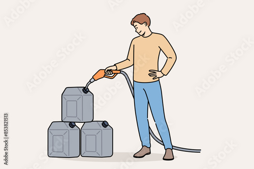 Man pours gasoline into tanks at gas station to stock up on fuel for car in case of oil crisis. Positive guy uses tank cars to store gasoline or kerosene when traveling long distances