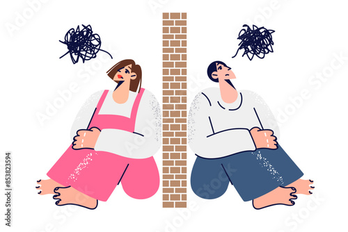 Quarrel between man and woman who sense obstacles in relationship, sitting on opposite sides of wall