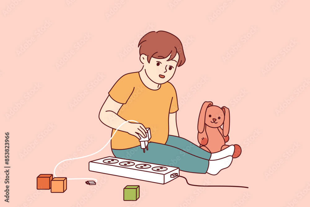 Little boy plays with electrical appliances at risk of getting electric shock due to lack of attention from parents. Child spends time alone playing with electrical outlet that can cause injury Little boy plays with electrical appliances at risk of getting electric shock due to lack of attention from parents. Child spends time alone playing with electrical outlet that can cause injury