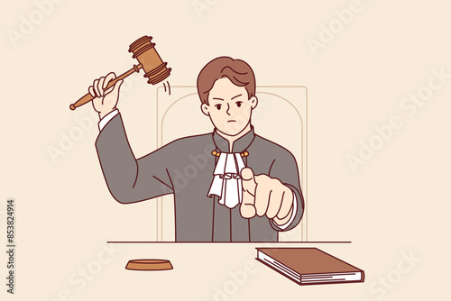 Stern judge pronounces verdict and points finger at screen after hitting gavel and announcing prison term. Angry judge sits at table demonstrating inflexibility and desire to punish criminal