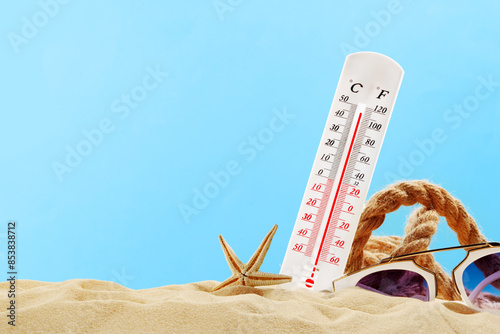 Thermometer Reading High Temperature on Sandy Beach