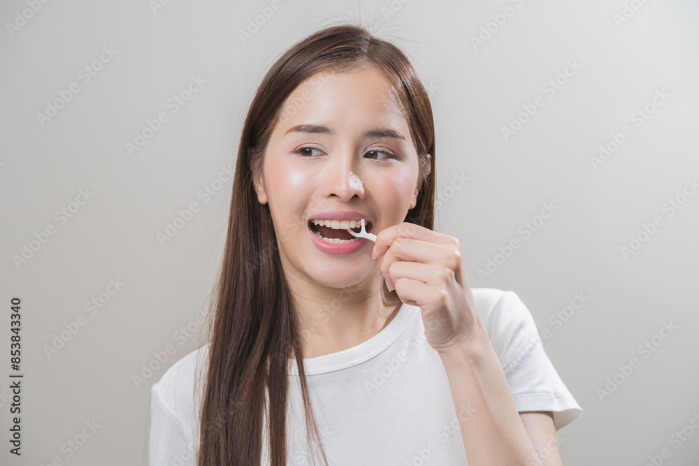 Flossing teeth, dental care hygiene, asian young woman flossing teeth with dental floss pick, smile happy with perfect white teeth, using tooth floss cleaning, healthy teeth isolated on background. Flossing teeth, dental care hygiene, asian young woman flossing teeth with dental floss pick, smile happy with perfect white teeth, using tooth floss cleaning, healthy teeth isolated on background.
