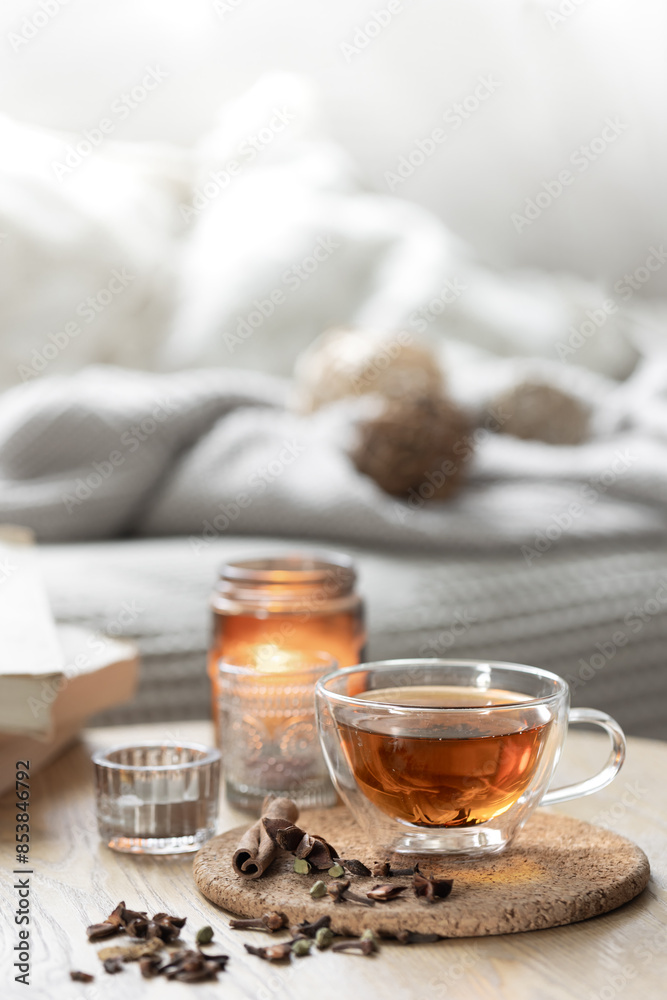 Still life with a cup of tea, books and a candle in a candlestick. Still life with a cup of tea, books and a candle in a candlestick.