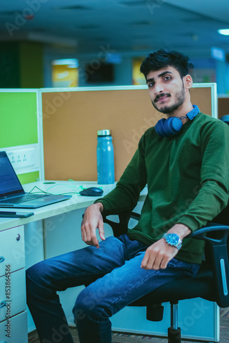 Young man working on his laptop in a modern office.