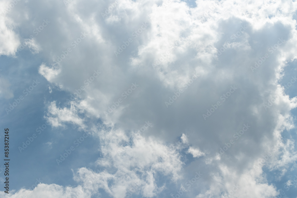 Background of blue sky with white clouds and the sun shining through the clouds Background of blue sky with white clouds and the sun shining through the clouds