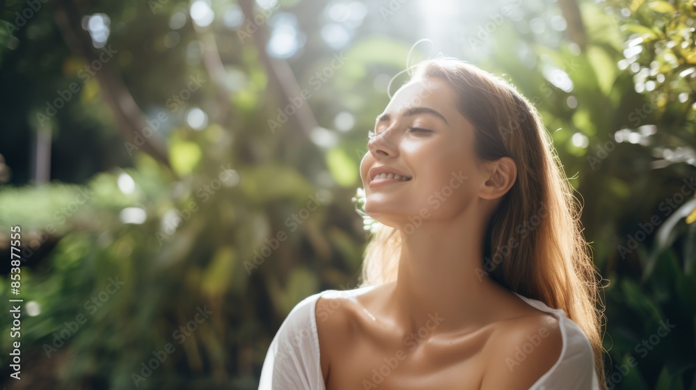 Young woman with long, blonde hair and natural makeup smiling blissfully with closed eyes, enjoying the sunshine in a lush garden. She wears a light top, radiating happiness and tranquility Young woman with long, blonde hair and natural makeup smiling blissfully with closed eyes, enjoying the sunshine in a lush garden. She wears a light top, radiating happiness and tranquility