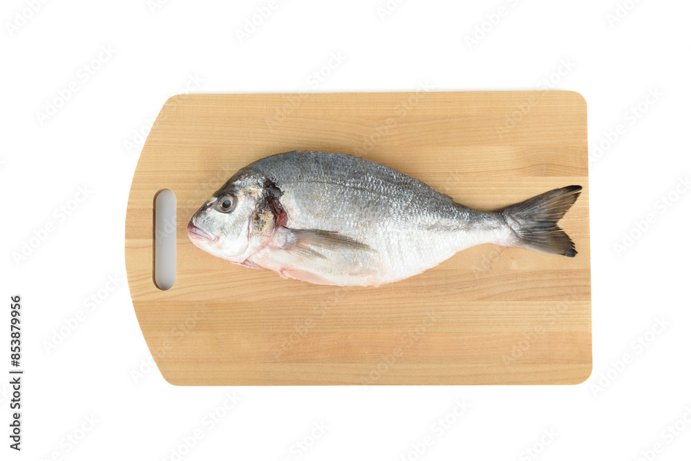 Fototapeta premium Shredded and scaled dorada fish on a cutting board.