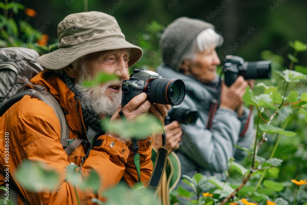 Fototapeta premium Senior couple photographing nature in forest 