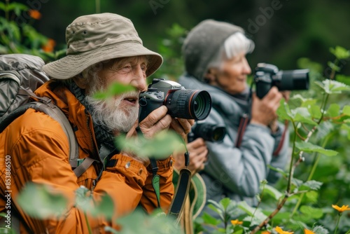 Senior couple photographing nature in forest 
