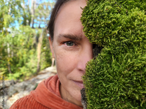 face middle aged woman half covered with moss wood outdoor. Earth Day. World Environment Day. aroma therapy. 