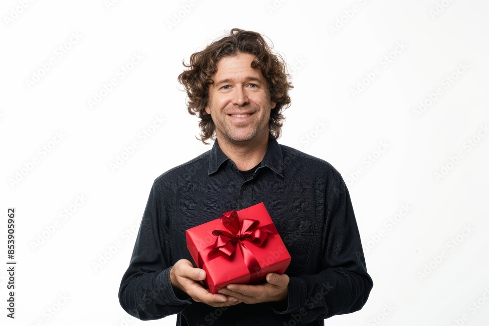 Portrait of a glad man in his 40s holding a gift on white background Portrait of a glad man in his 40s holding a gift on white background