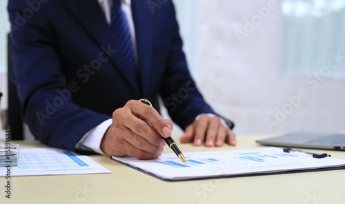 Looking at busy businessman's hands Using smartphones and laptops in the office, AI creates images.