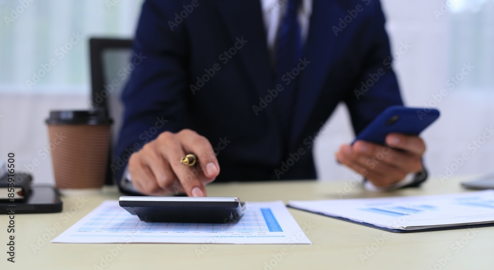 Looking at busy businessman's hands Using smartphones and laptops in the office, AI creates images. Looking at busy businessman's hands Using smartphones and laptops in the office, AI creates images.
