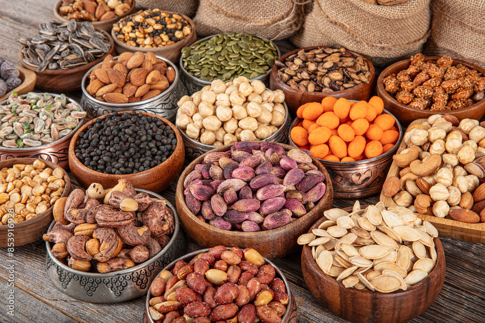 Assorted nuts and seeds background. mixed raw food for snacking, top view. different nuts background. Collage nuts and seeds in shell, top view. assorted healthy food background. Assorted nuts and seeds background. mixed raw food for snacking, top view. different nuts background. Collage nuts and seeds in shell, top view. assorted healthy food background.
