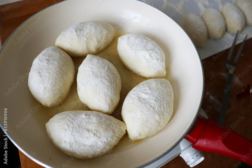 process of baking pies from yeast dough in a frying pan