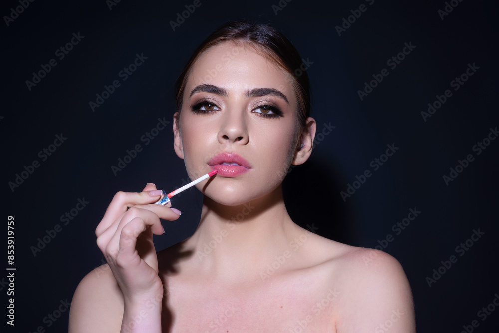 Beautiful young woman applying red lipstick on lips, studio color background. Sexy girl applied lipstick. Young nodel holding pink lipstick. Red lips make up. Beautiful woman putting lipstick on lips. Beautiful young woman applying red lipstick on lips, studio color background. Sexy girl applied lipstick. Young nodel holding pink lipstick. Red lips make up. Beautiful woman putting lipstick on lips.