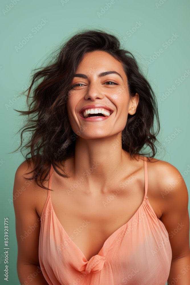 Portrait photo of a smiling Southeast Asian woman, 40 years old, winking on a pastel aqua background
Portrait photo of a smiling Southeast Asian woman, 40 years old, winking on a pastel aqua background