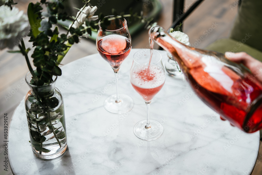 Pouring champagne at a dinner party or a date in a restaurant.