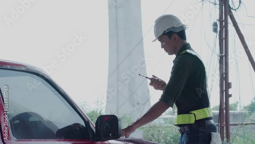 civil engineer in workwear discussing building on radio communication gesturing with hand, close up, background.