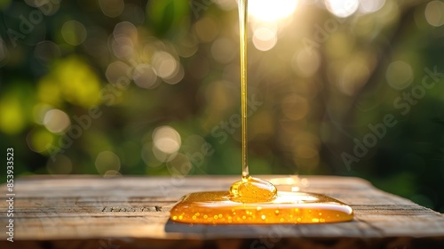Honey being drizzled onto a wooden platform photo