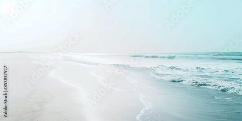 A serene beach with white sand and gentle waves lapping at the shore