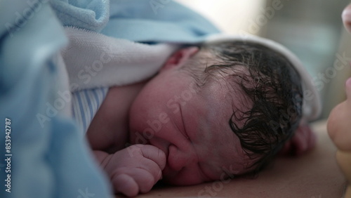Obraz na plátně Close-up of newborn baby right after birth resting on mother's chest emphasizing skin to skin contact