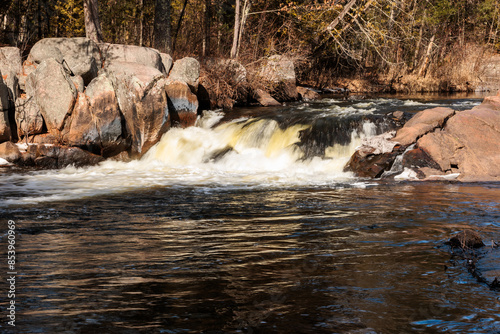 The Pike River is flowing over the uppder falls at Dave's Falls County Park, Amberg, Wisconsin in mid-March photo