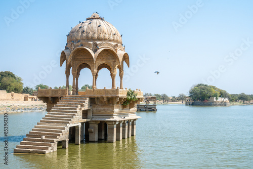 A stone structure situated in the center of a body of water photo