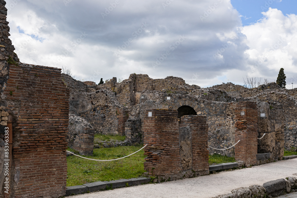 View of the ruins of residential buildings on the street in the ancient city of Pompeii. View of the ruins of residential buildings on the street in the ancient city of Pompeii.