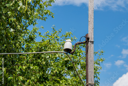 old electrical post, porcelain insulator tied with laces