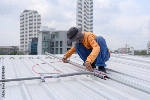 Worker installs solar panels. Worker installs solar panels at a solar farm field.