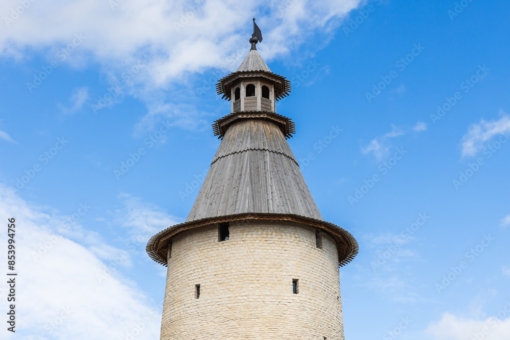 Round stone tower with wooden rooftop. Kremlin of Pskov, Russia Round stone tower with wooden rooftop. Kremlin of Pskov, Russia
