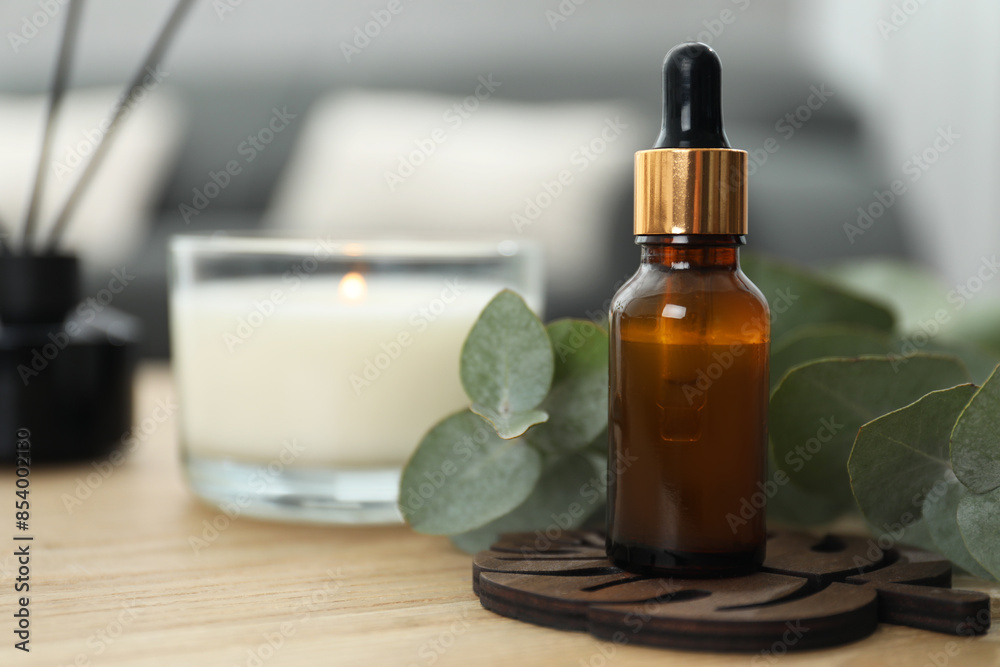 Aromatherapy. Bottle of essential oil and eucalyptus leaves on wooden table Aromatherapy. Bottle of essential oil and eucalyptus leaves on wooden table