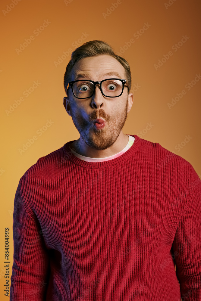 Handsome man in stylish attire playfully contorting his face while wearing glasses. Handsome man in stylish attire playfully contorting his face while wearing glasses.