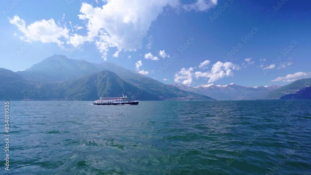 Ferry crossing Lake Como Italy with Alps in the back Ferry crossing Lake Como Italy with Alps in the back