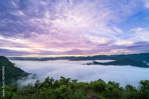 Orange sky and sea of clouds before sunrise. A peaceful, refreshing feeling. View of the mountains surrounding Emerald Reservoir. Xindian District, Taiwan.