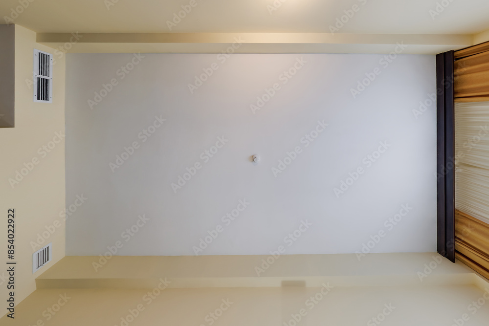 Fototapeta premium suspended ceiling with halogen spots lamps and drywall construction in empty room in apartment or house. Stretch ceiling white and complex shape.