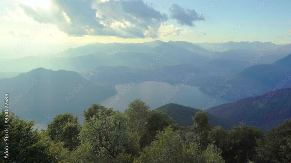 Wide shot of Lugano Switzerland with Lake and Mountains Wide shot of Lugano Switzerland with Lake and Mountains